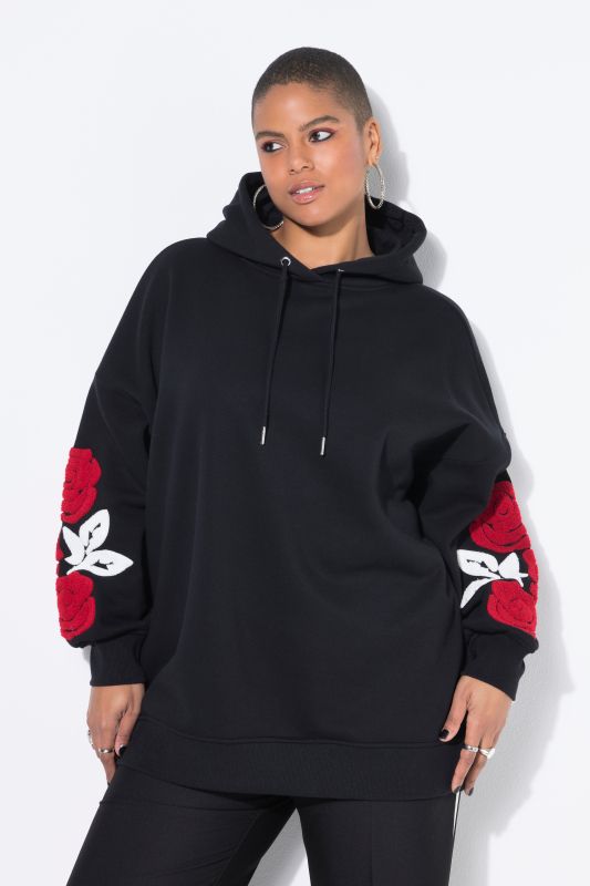 Sweat à capuche très oversize. Imprimé roses sur les manches