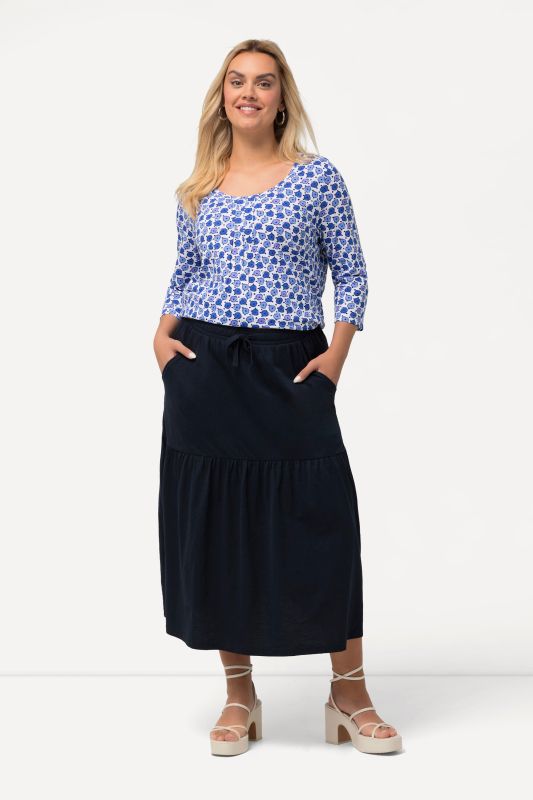 Jupe en jersey texturé, ligne A et volant. Taille élastique