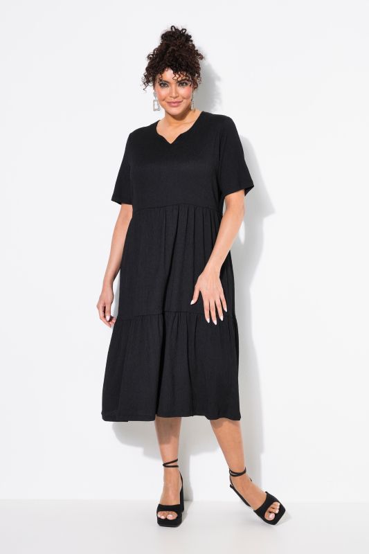 Robe avec volants superposés, décolleté rond et manches 3/4, coupe évasée