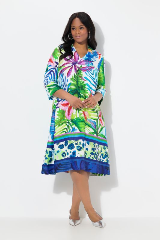 Robe midi en satin. Motif feuilles et coupe évasée. Manches 3/4 et col chemise