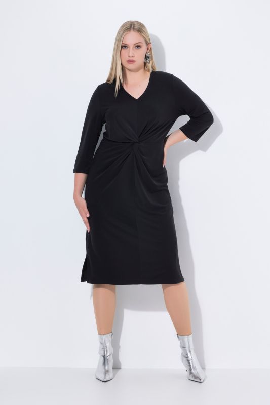 Robe midi avec décolleté en V et manches 3/4. Nœud fantaisie