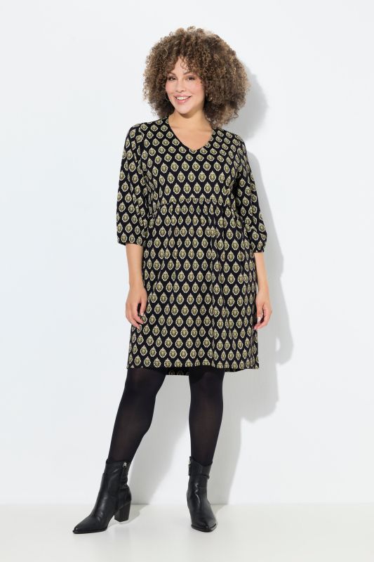 Robe en jersey, coupe évasée. Col en V et manches 3/4