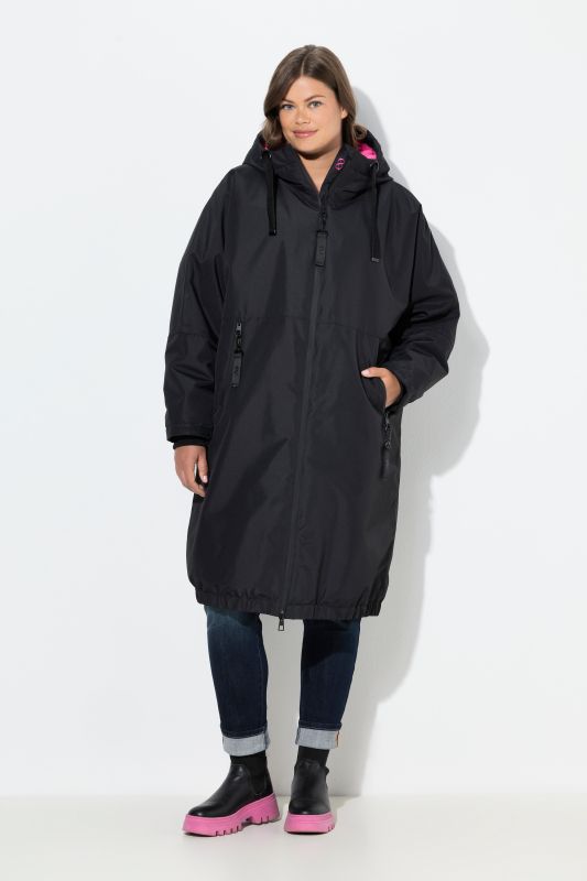 Veste technique oversize à capuche. Doublure polaire bouclée. Fermeture éclair à double sens