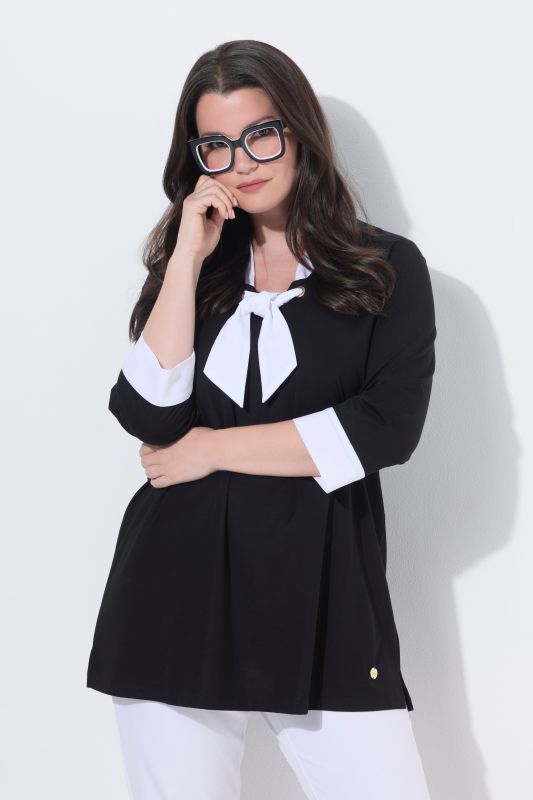 Blouse à ruban fantaisie. Décolleté V et manches 3/4. Coupe évasée