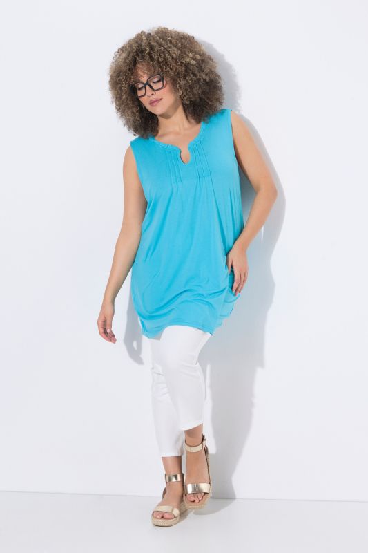 Top long sans manches, décolleté en V avec passepoils et col légèrement montant