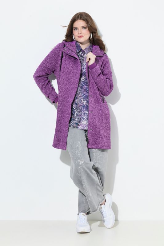 Veste en maille polaire à capuche. Poches zippées et fermeture à glissière à double sens.