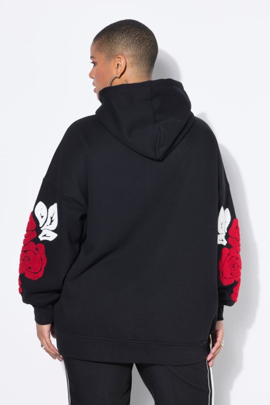 Sweat à capuche très oversize. Imprimé roses sur les manches