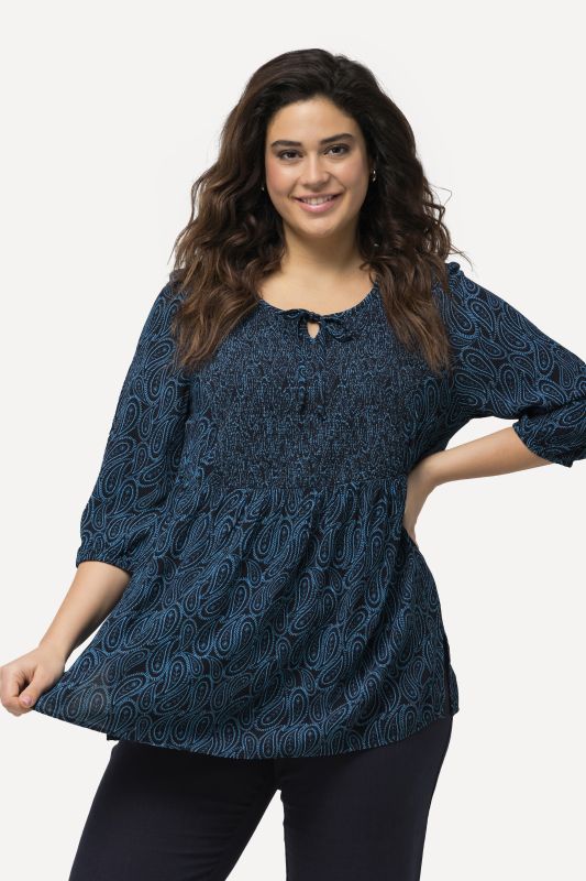 Blouse smockée avec encolure ronde et manches 3/4. Ligne A