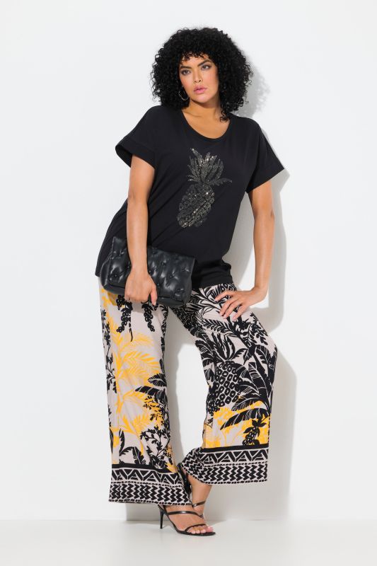 Pantalon à motif palmiers. Jambe droite et large. Taille élastique