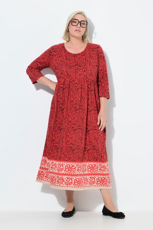 Robe en jersey. Col rond et manches 3/4. Poches et coupe évasée