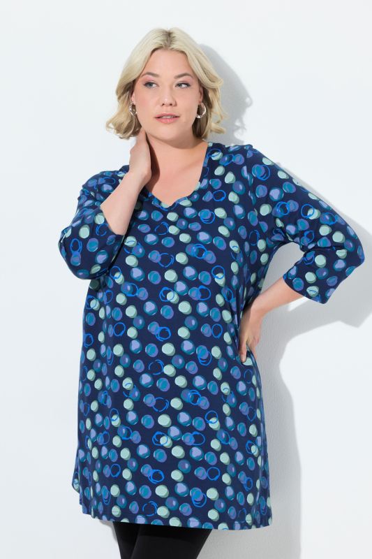 T-shirt long, motif à pois. Col en V et manches 3/4. Coupe évasée
