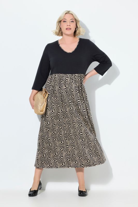 Robe en jersey, coupe évasée. Col en V et manches 3/4