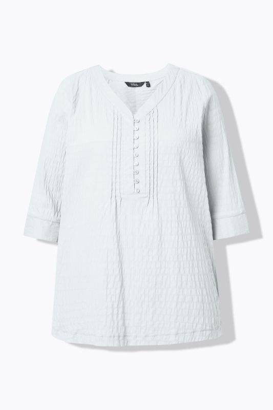 Tunique en tissu gaufré. Manches 3/4. Décolleté cœur et plis fantaisie