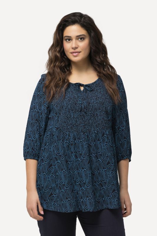 Blouse smockée avec encolure ronde et manches 3/4. Ligne A
