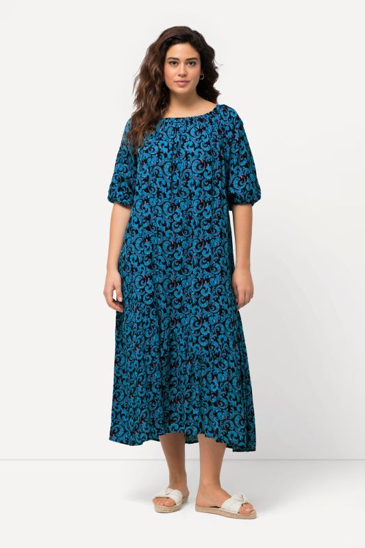 Robe midi à col rond et manches courtes. Volant à la base et motif vrilles