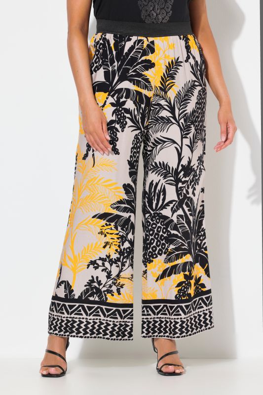 Pantalon à motif palmiers. Jambe droite et large. Taille élastique