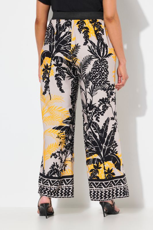 Pantalon à motif palmiers. Jambe droite et large. Taille élastique