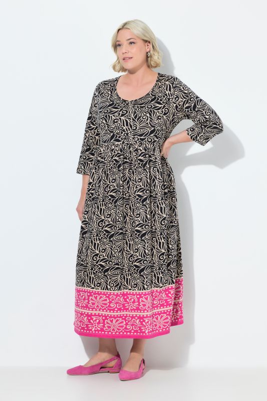 Robe en jersey. Col rond et manches 3/4. Poches et coupe évasée