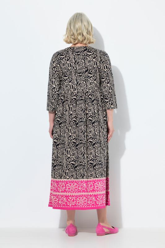 Robe en jersey. Col rond et manches 3/4. Poches et coupe évasée