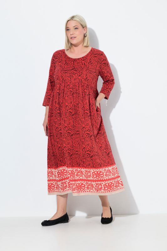 Robe en jersey. Col rond et manches 3/4. Poches et coupe évasée