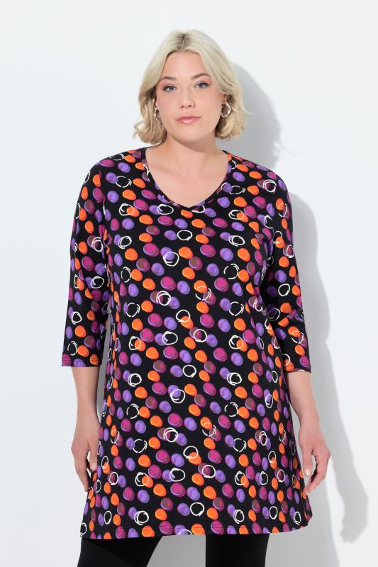 T-shirt long, motif à pois. Col en V et manches 3/4. Coupe évasée