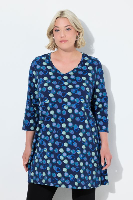 T-shirt long, motif à pois. Col en V et manches 3/4. Coupe évasée