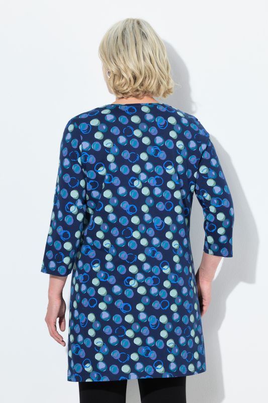 T-shirt long, motif à pois. Col en V et manches 3/4. Coupe évasée