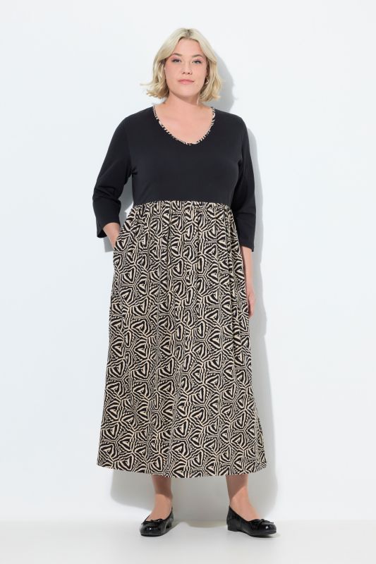 Robe en jersey, coupe évasée. Col en V et manches 3/4