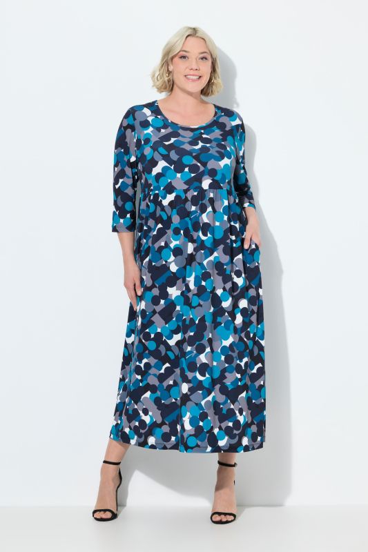 Robe en jersey, imprimé pois. Col rond et manches 3/4. Coupe évasée