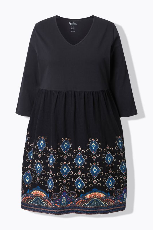 Robe en jersey, coupe évasée et poches. Col en V et manches 3/4