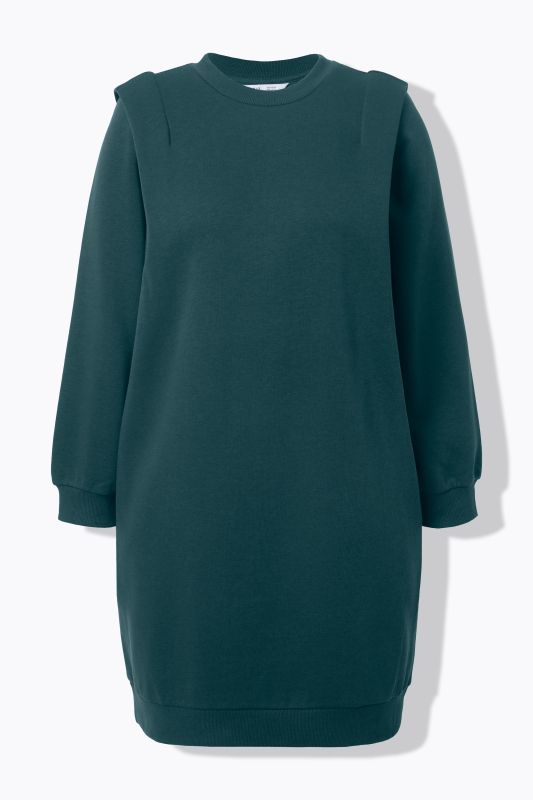 Robe en molleton, coupe oversize. Épaules travaillées, encolure ronde et manches longues.