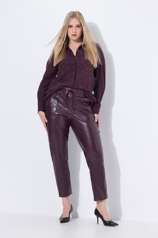 Pantalon 7/8 en similicuir. Passepoils et taille élastique
