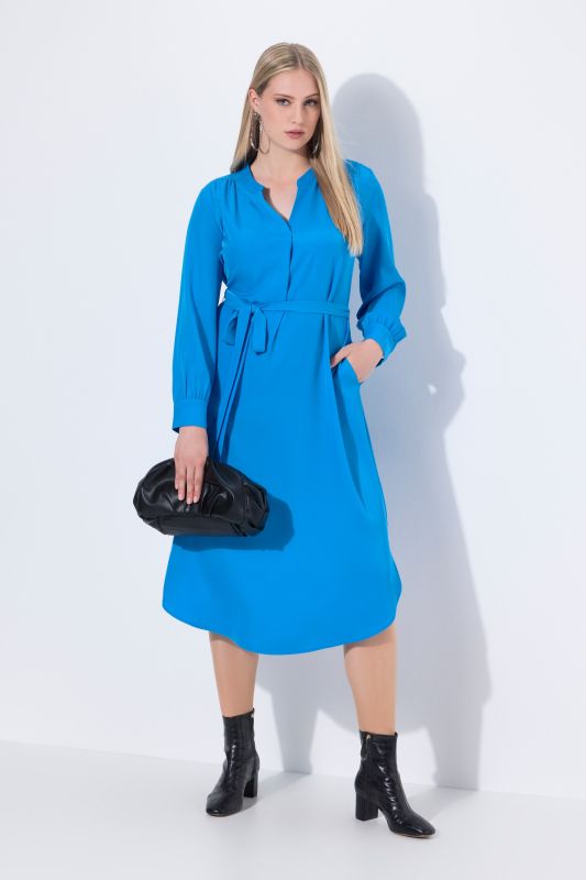 Robe midi à manches longues. Décolleté en V et ceinture à nouer. Poches.
