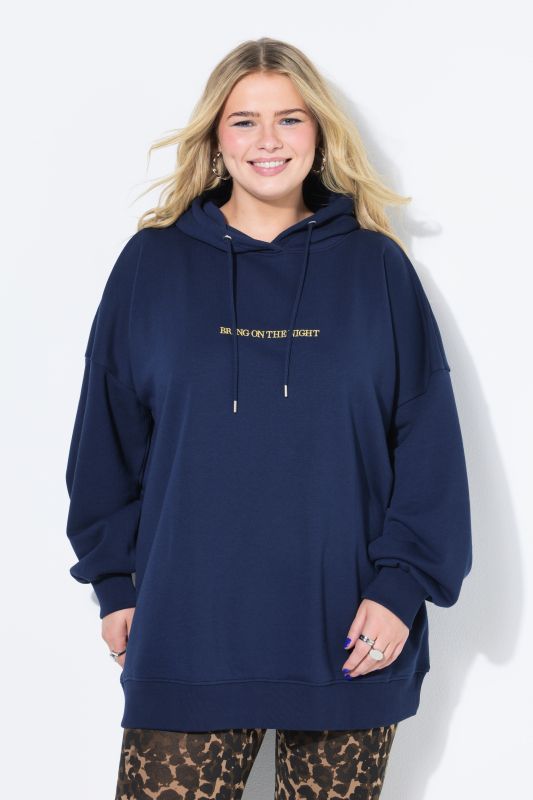 Sweat à capuche oversize. Message scintillant