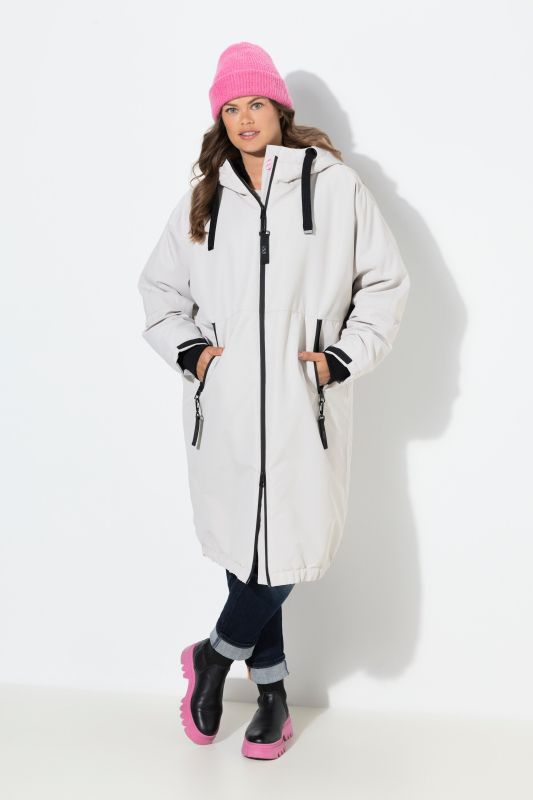 Veste technique oversize à capuche. Doublure polaire bouclée. Fermeture éclair à double sens