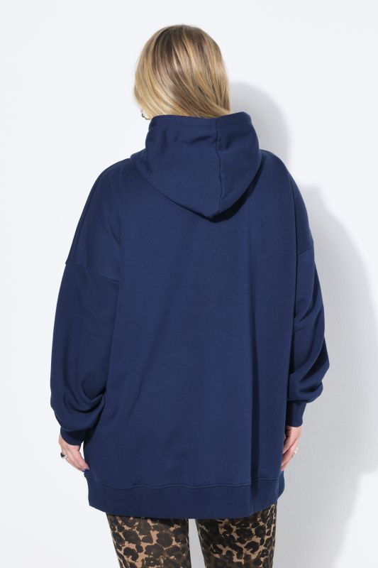 Sweat à capuche oversize. Message scintillant