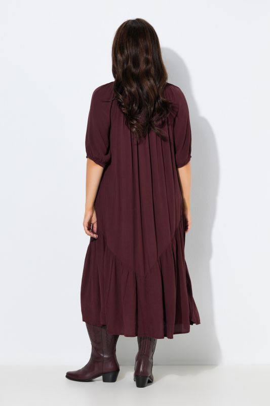 Robe midi à col rond et manches courtes. Base volantée et matière texturée