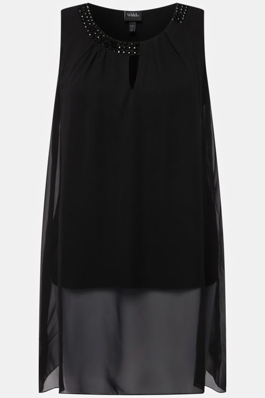 Tunique longue, sans manches. Coupe évasée. Décolleté rond à pierres fantaisie