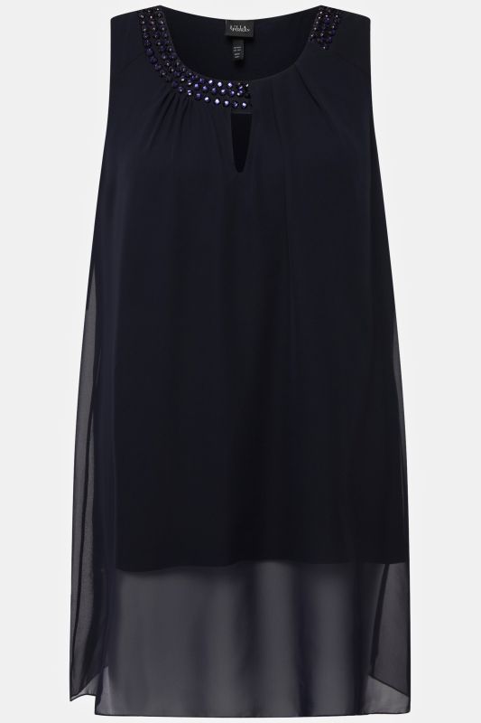 Tunique longue, sans manches. Coupe évasée. Décolleté rond à pierres fantaisie