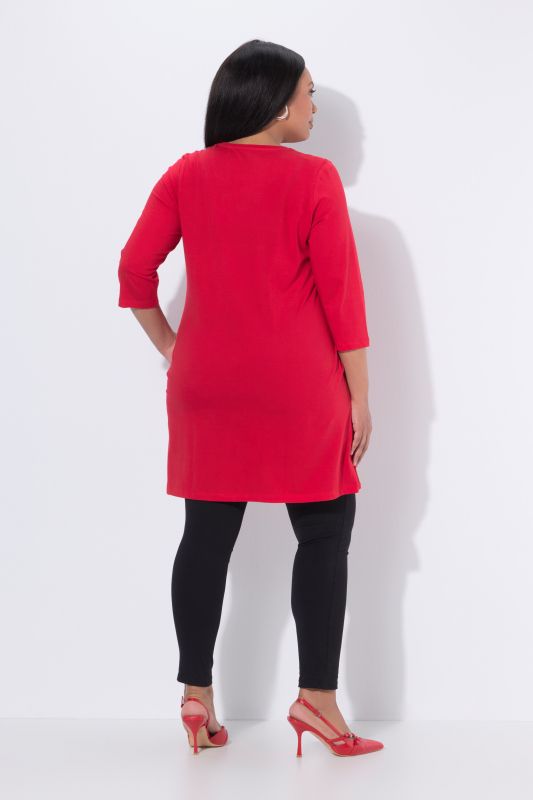 T-shirt long, coupe évasée. Manches 3/4, col V à rubans fantaisie