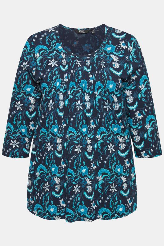 T-shirt à col rond et manches 3/4, passepoils. Coupe évasée.