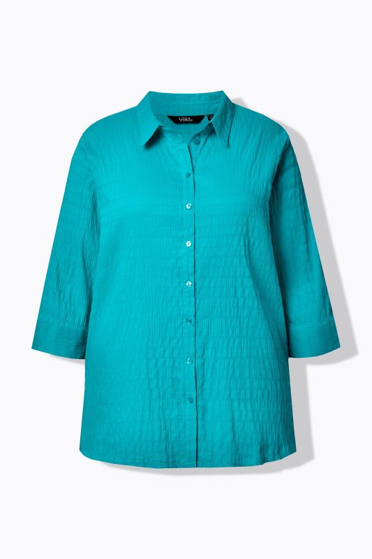 Chemisier en tissu gaufré. Col classique et manches 3/4