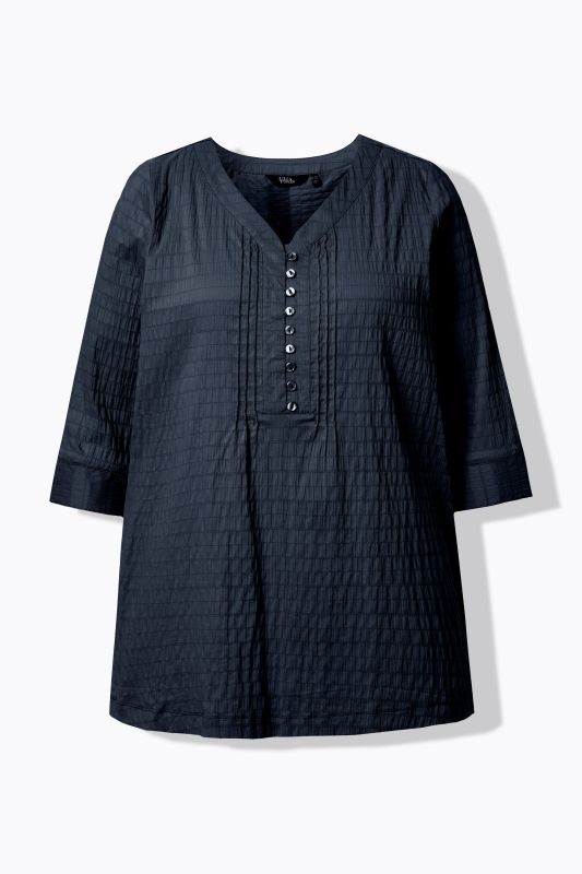 Tunique en tissu gaufré. Manches 3/4. Décolleté cœur et plis fantaisie