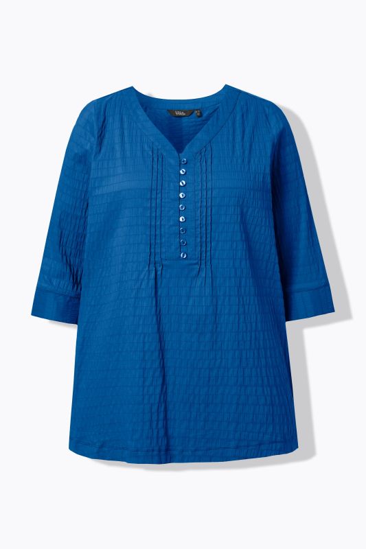 Tunique en tissu gaufré. Manches 3/4. Décolleté cœur et plis fantaisie