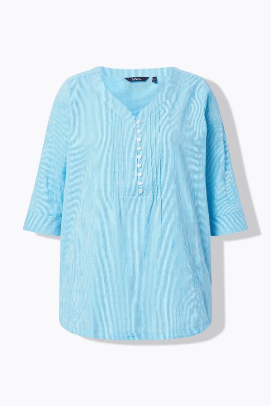 Tunique en tissu gaufré. Manches 3/4. Décolleté cœur et plis fantaisie