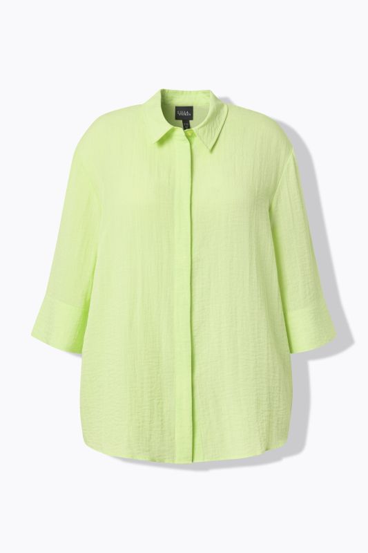 Chemisier à pli d'aisance. Manches 3/4 et col classique. Coupe évasée