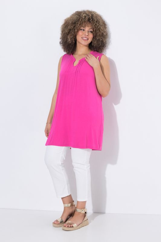 Top long sans manches, décolleté en V avec passepoils et col légèrement montant