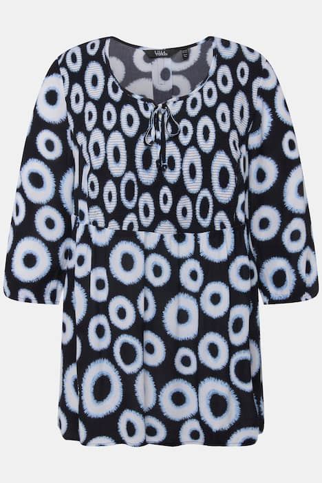 Blouse smockée à motif cercles. Col rond et manches 3/4. Coupe évasée