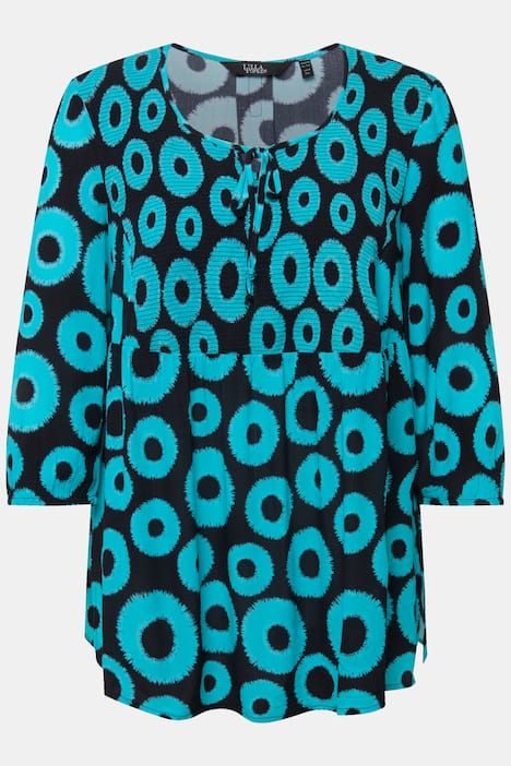 Blouse smockée à motif cercles. Col rond et manches 3/4. Coupe évasée