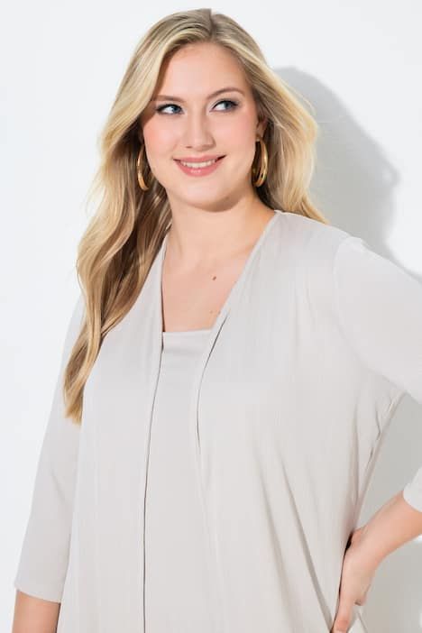 Gilet long en jersey côtelé. Coupe ouverte et encolure en V